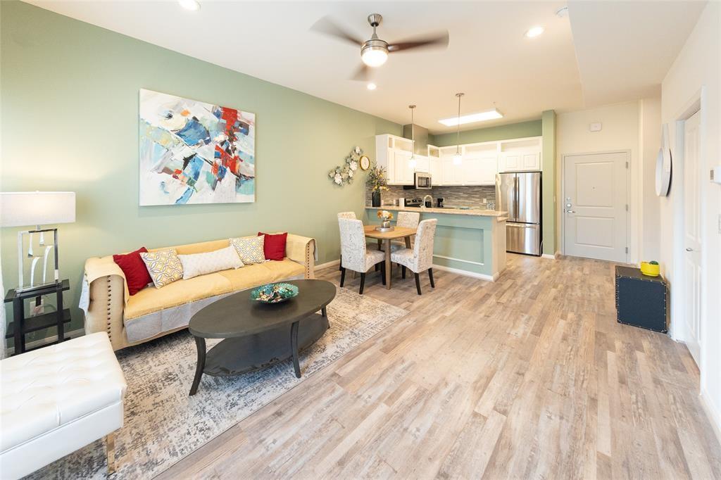 a living room with furniture and kitchen view