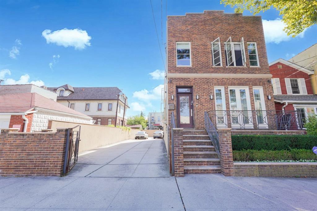 a front view of a residential apartment building with a yard