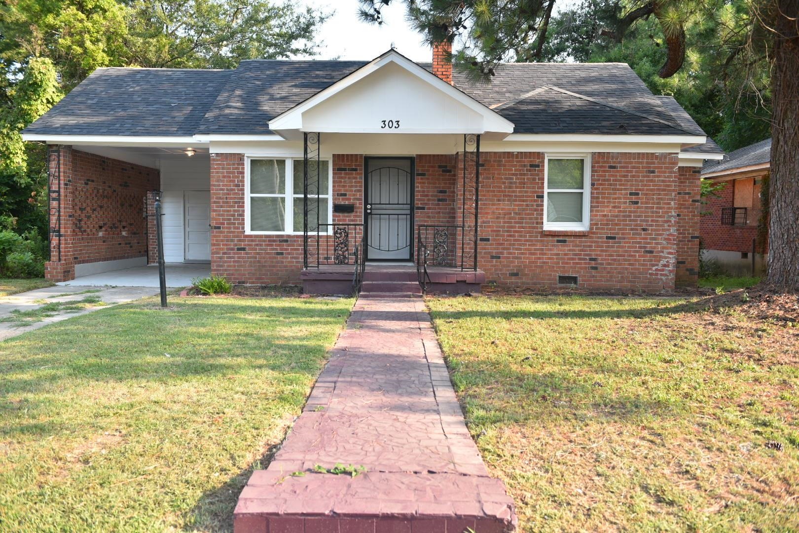 a front view of a house with a yard