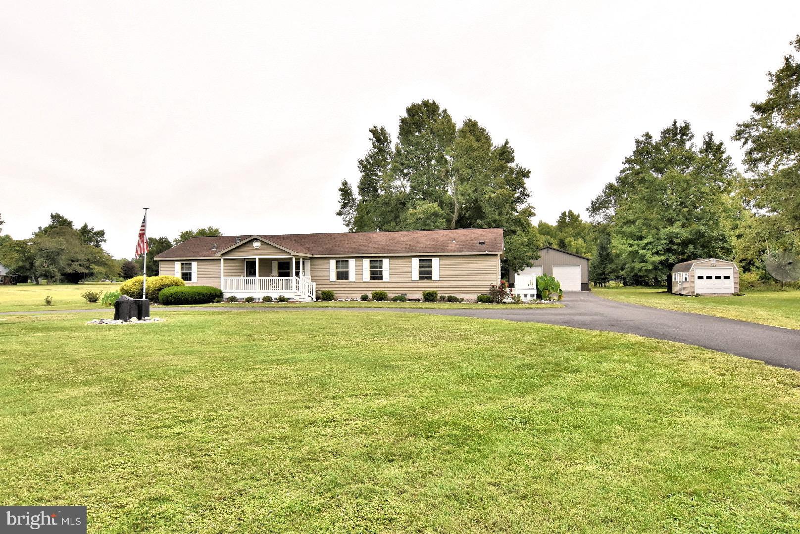 a front view of a house with a yard table and chairs