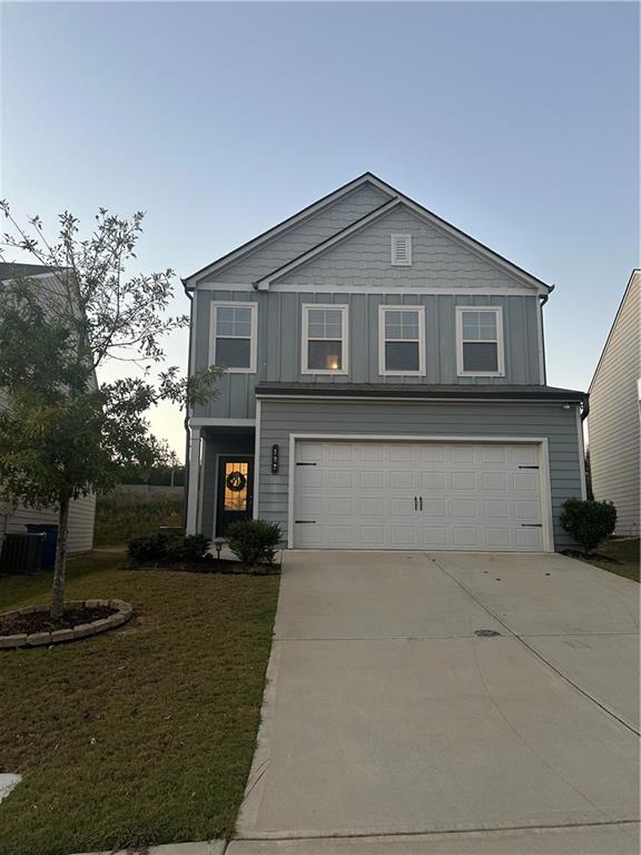 a front view of a house with a yard and garage