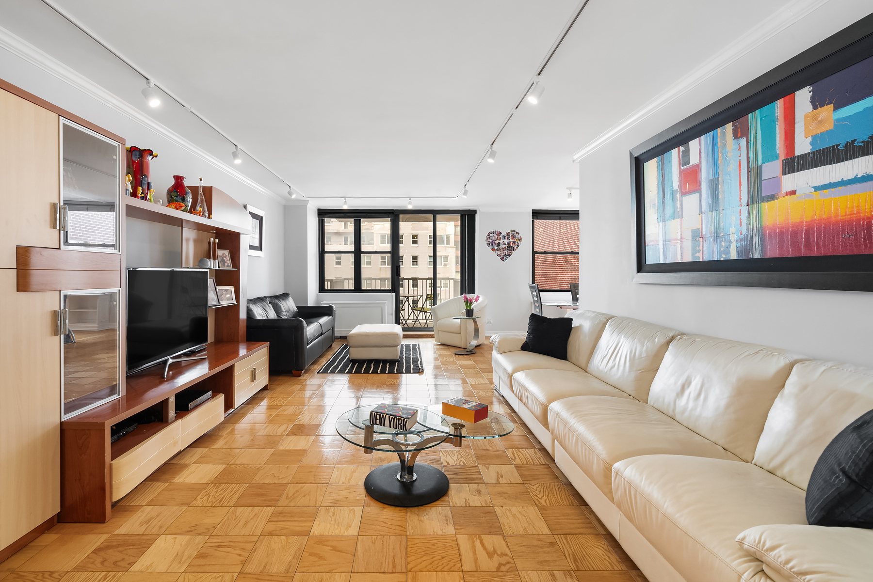 a living room with furniture wooden floor and a flat screen tv