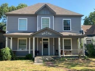 a front view of a house with garden and porch