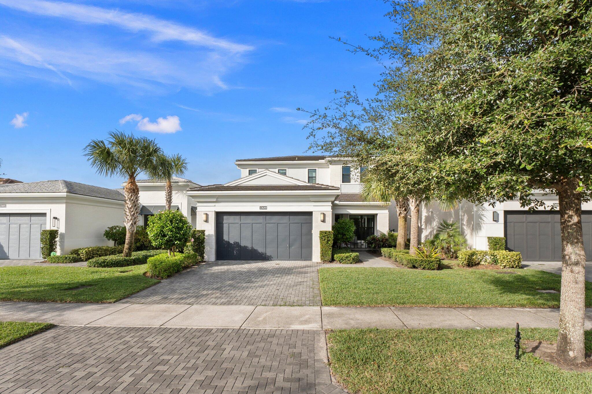 a front view of a house with a yard and a garage