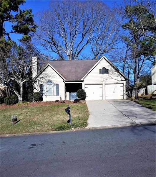 a view of white house with a yard