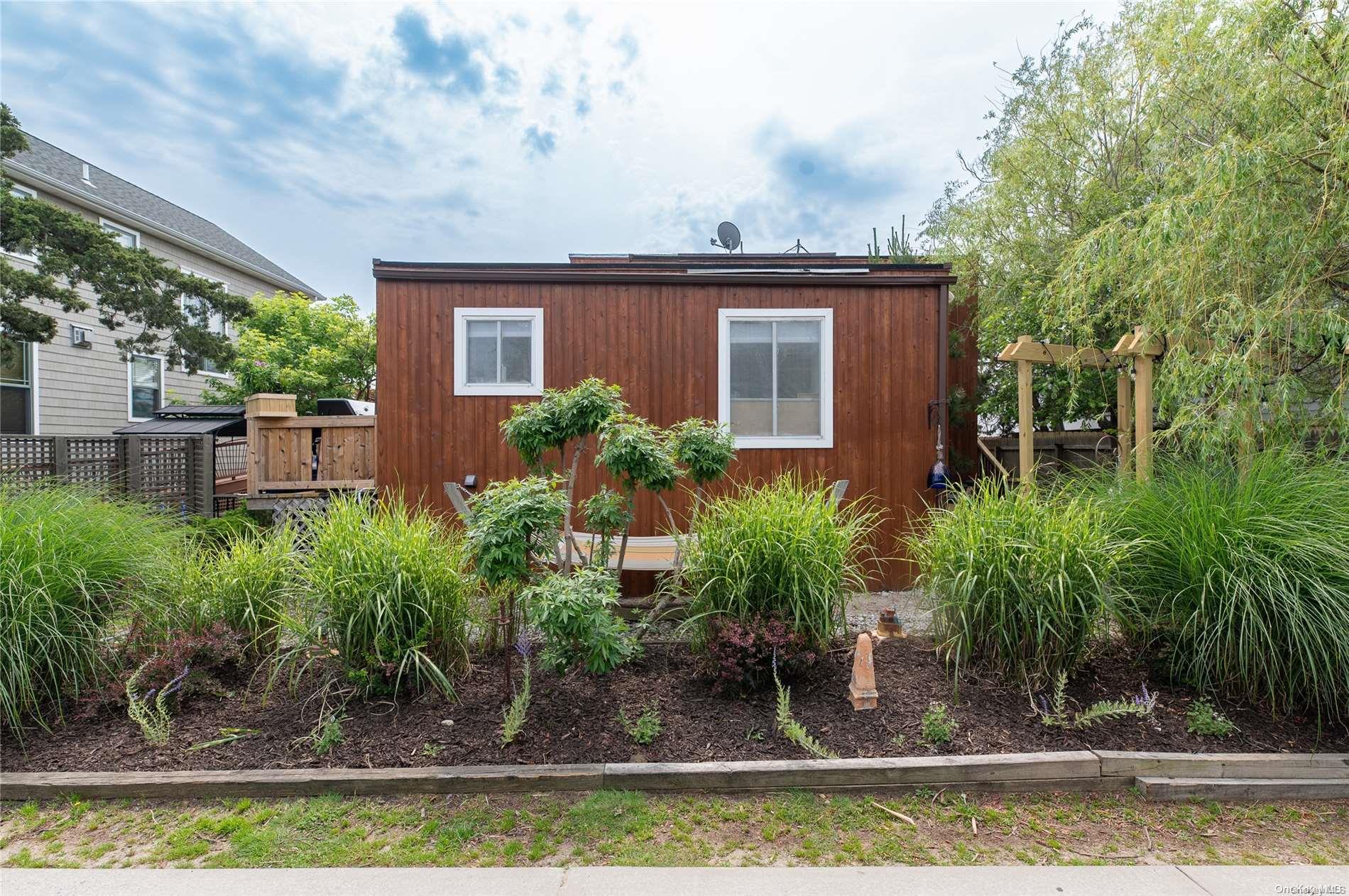 a view of a house with a yard and sitting area