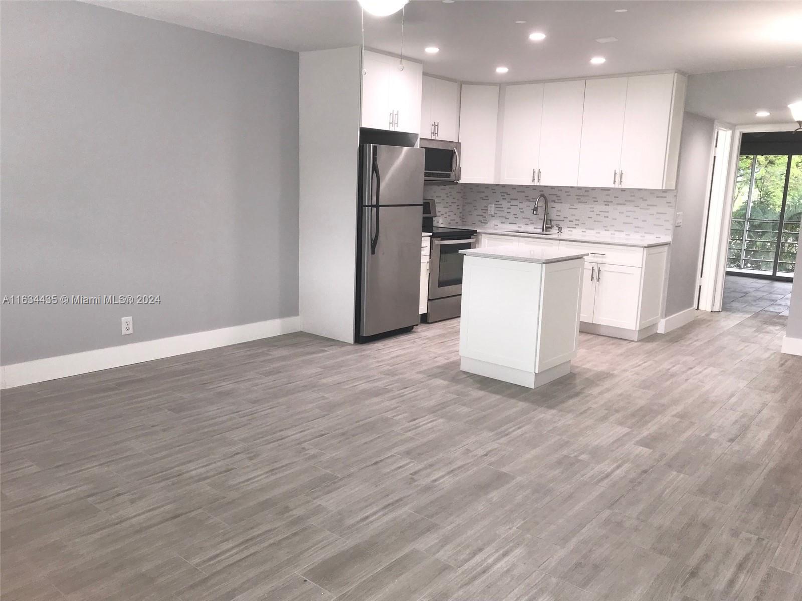 a view of kitchen with wooden floor