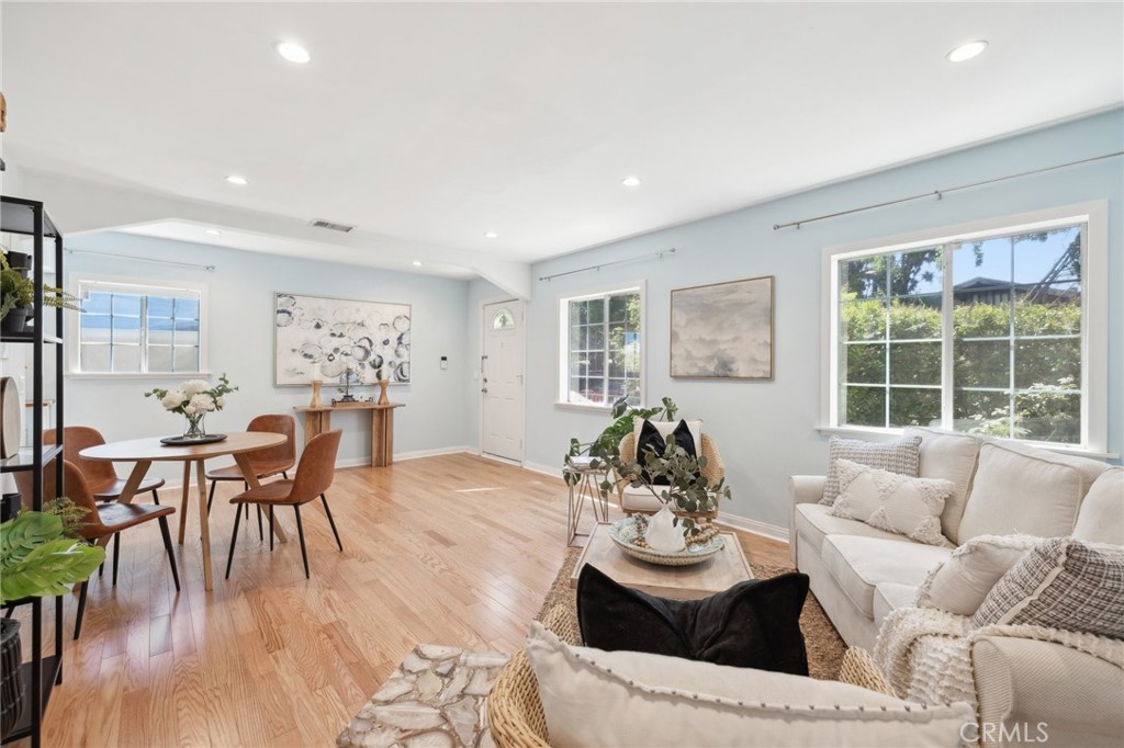 a living room with furniture and wooden floor