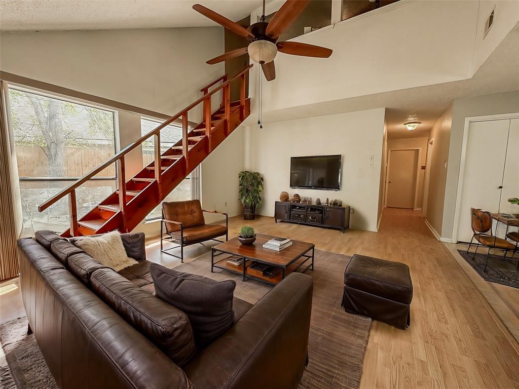 a living room with furniture and wooden floor