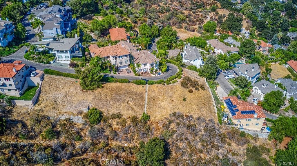 an aerial view of a houses with a yard