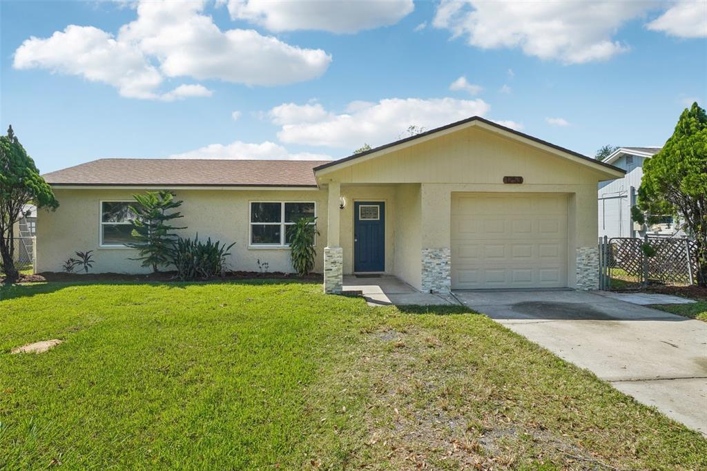 a front view of house with yard and green space