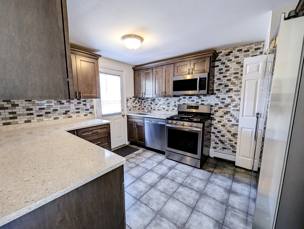 a kitchen with a stove and a refrigerator