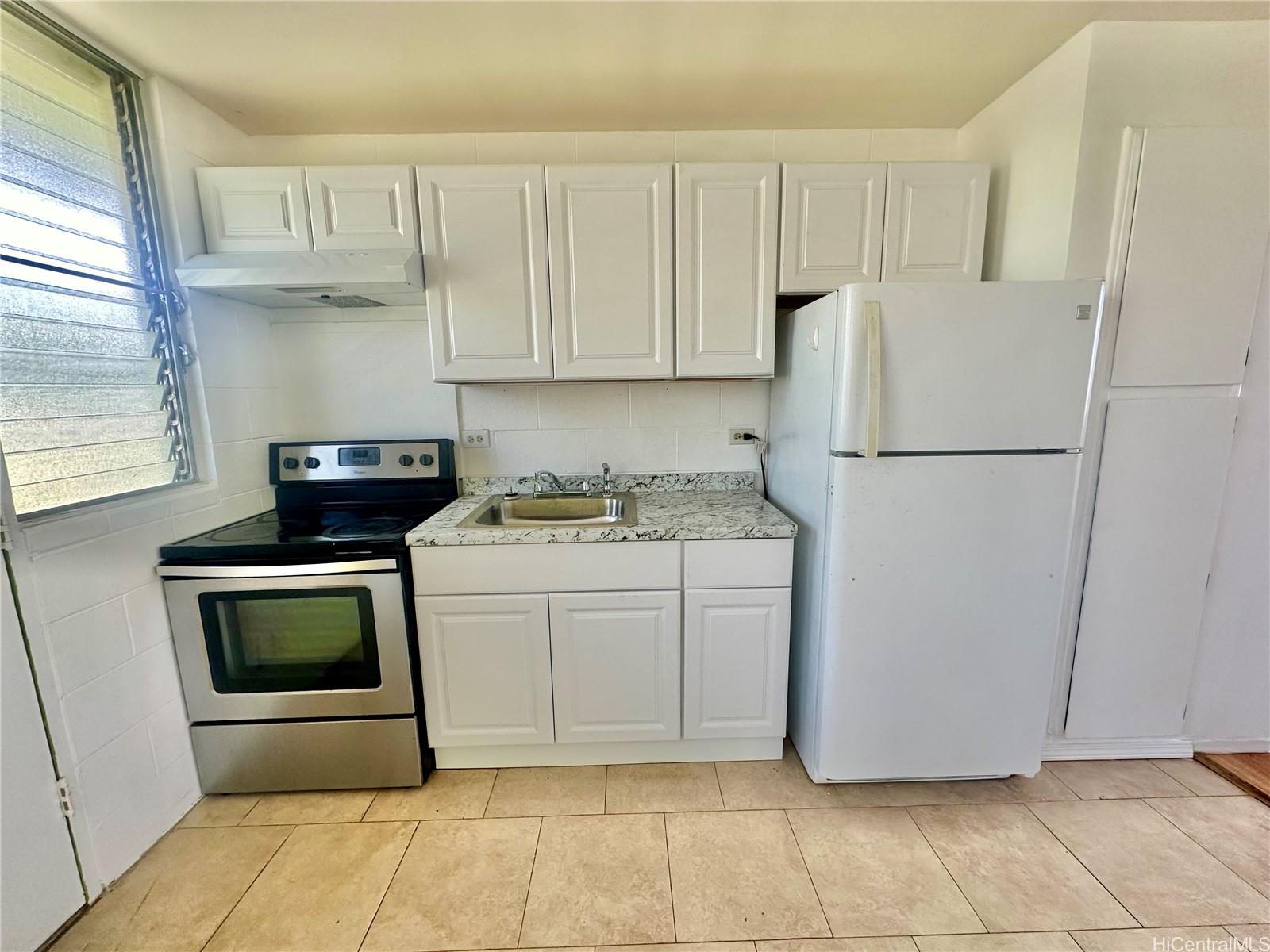 a kitchen with cabinets and white appliances