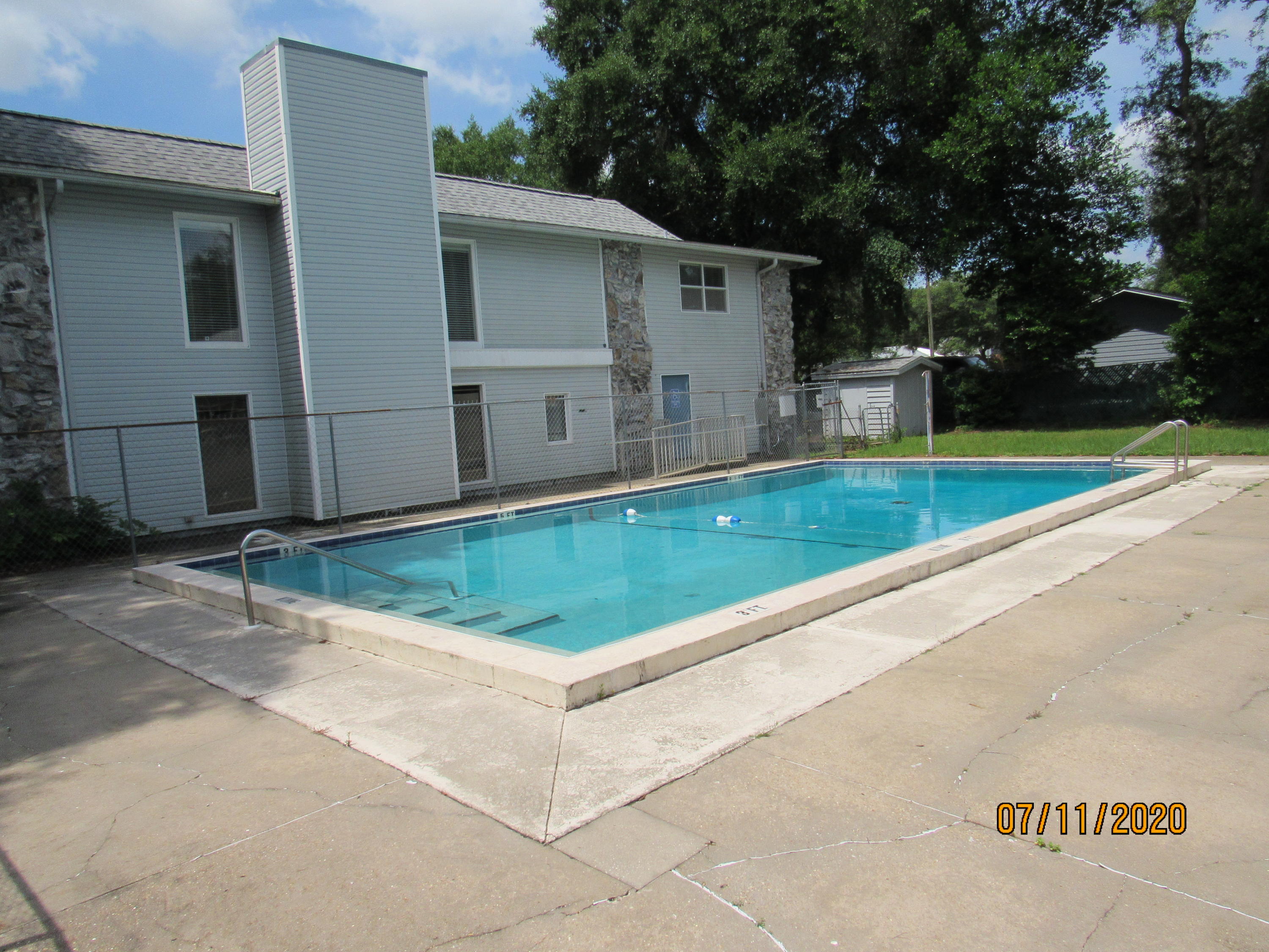 a view of a small pool with a yard