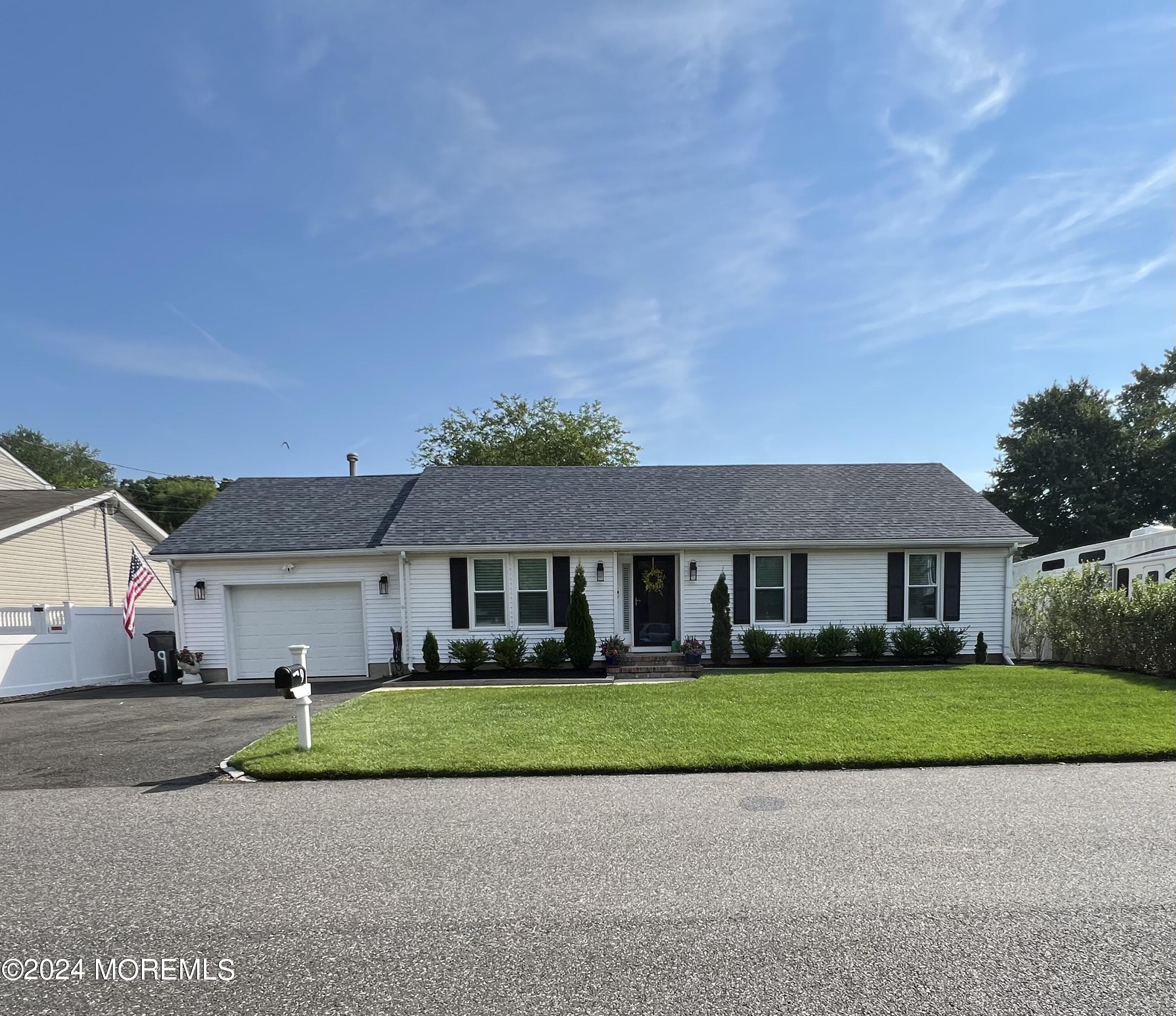 a view of house in front of a big yard