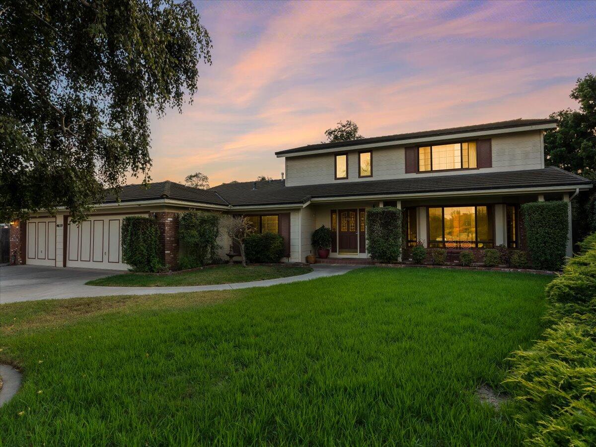 a front view of a house with a garden