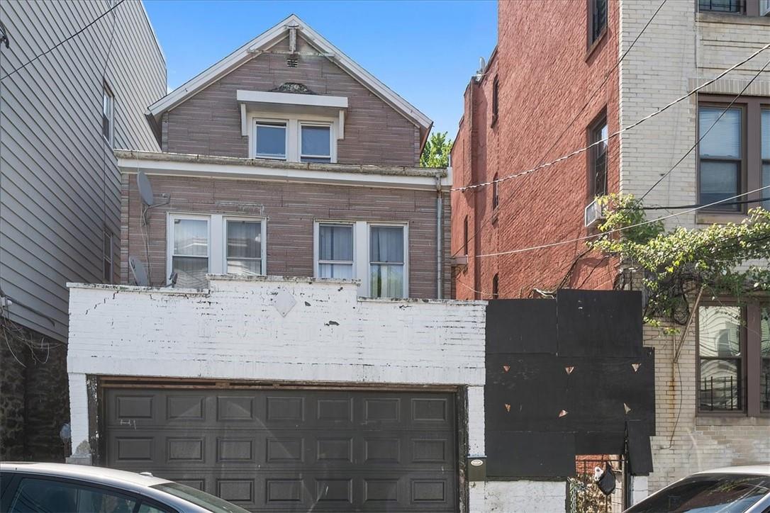 View of front of property with a garage