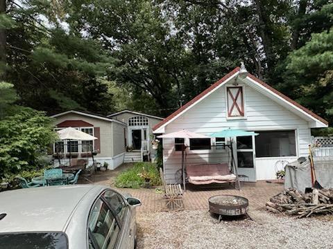 a front view of house with yard patio and outdoor seating