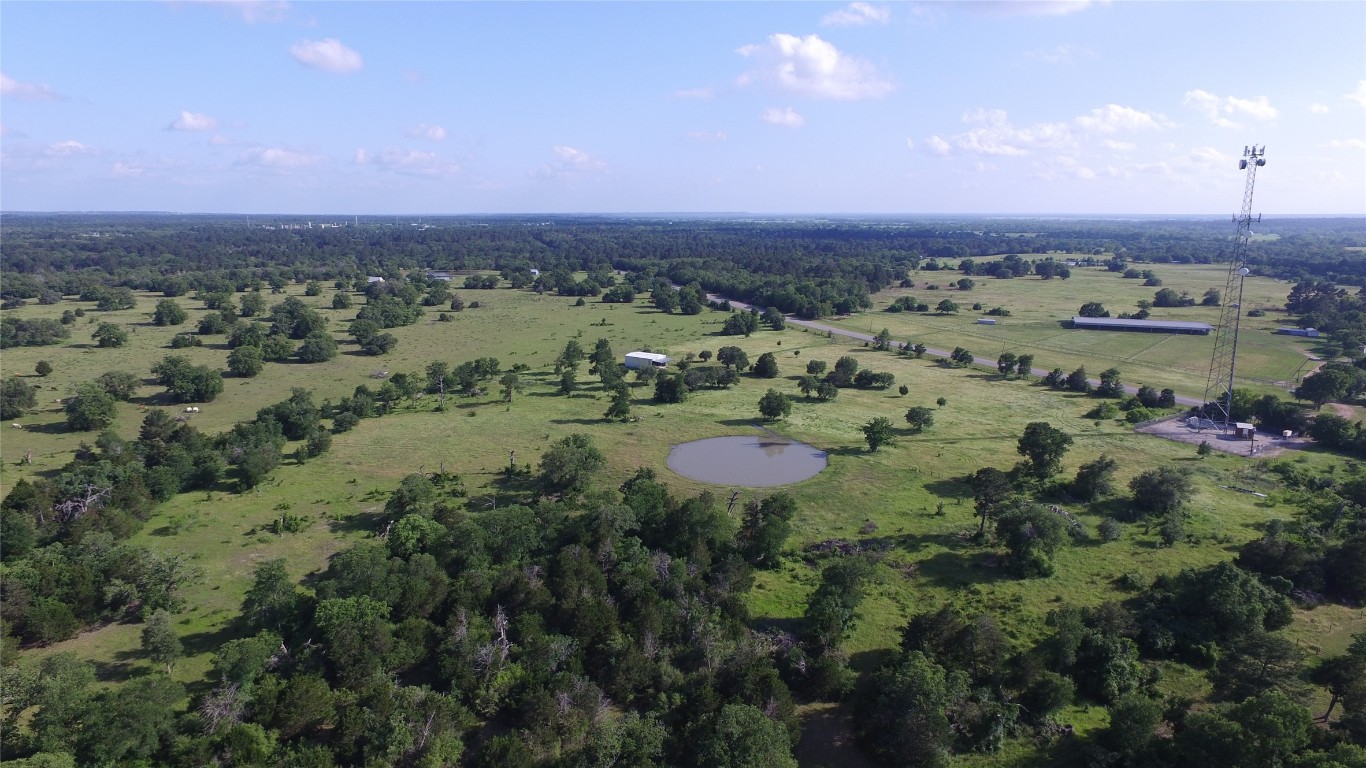 an aerial view of a houses with a yard