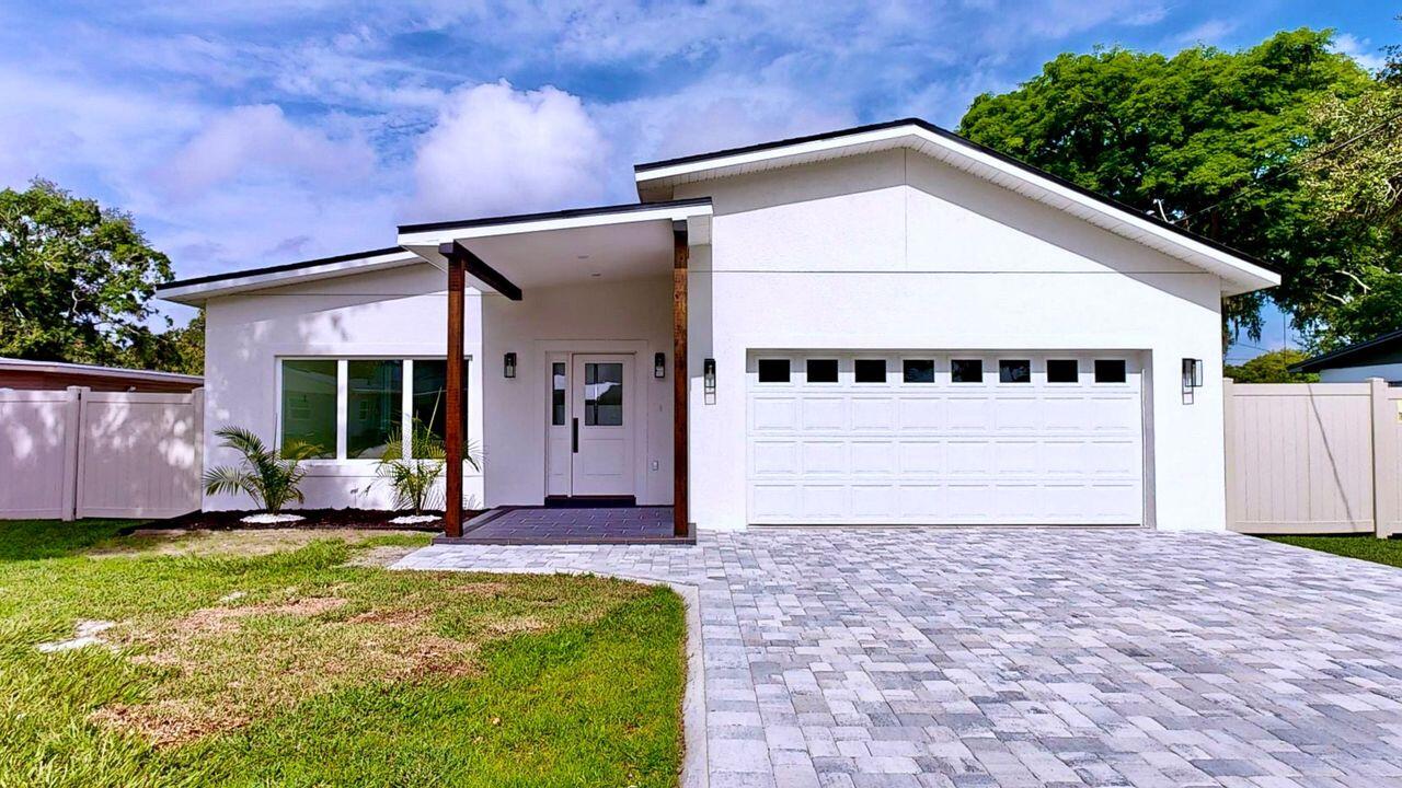 a front view of a house with a yard and garage