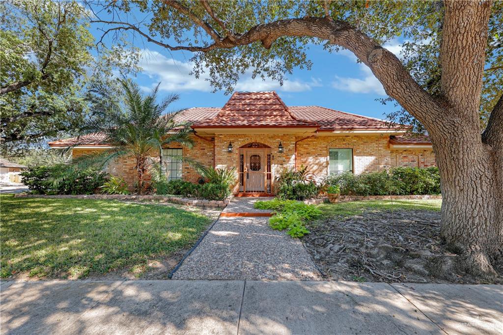 Mediterranean / spanish-style home with a front yard