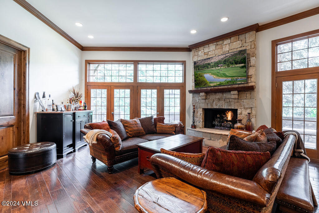 a living room with furniture fireplace and a large window