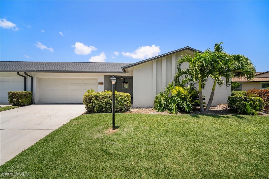 a front view of a house with a yard and garage