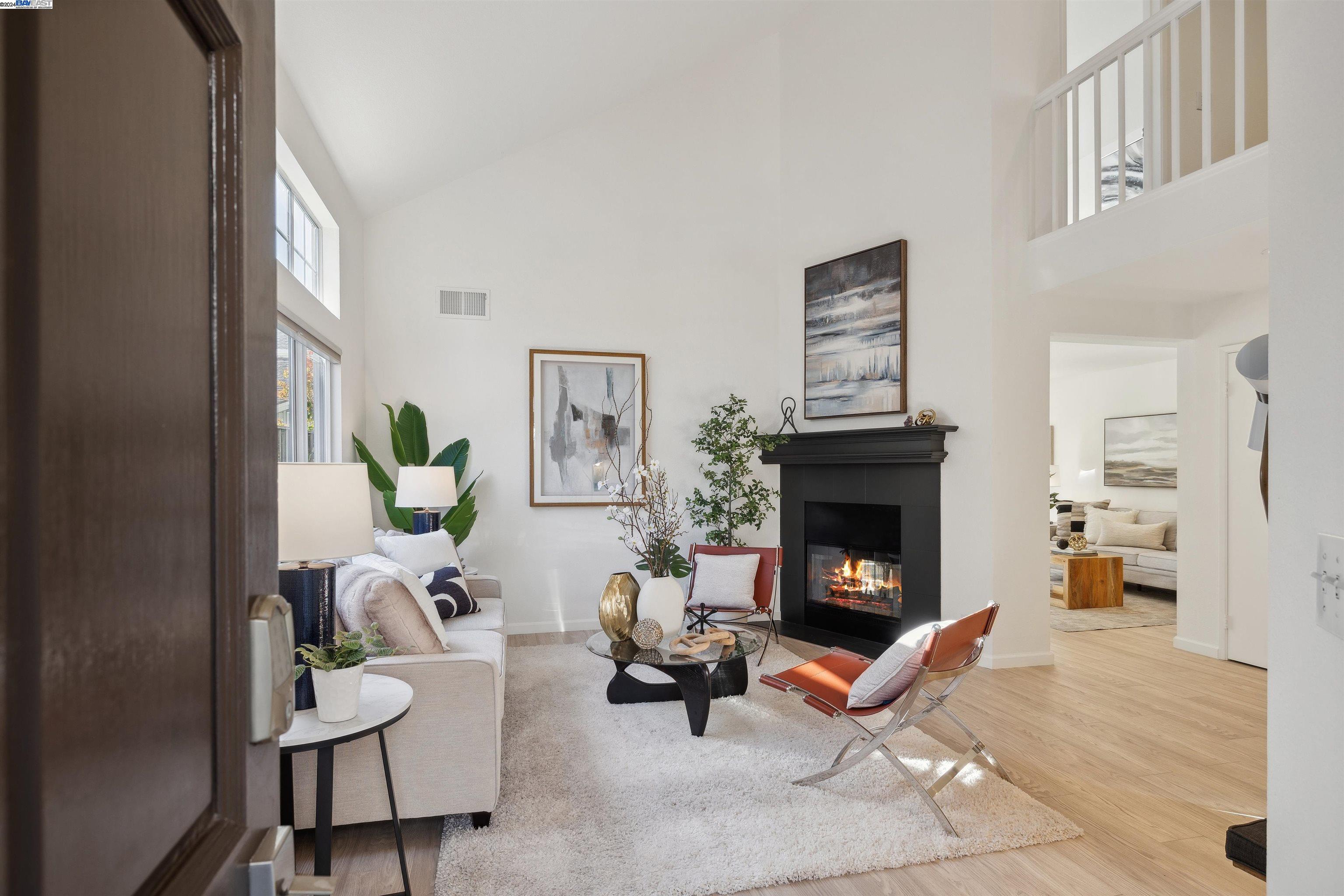 a living room with furniture a fireplace and next to a window