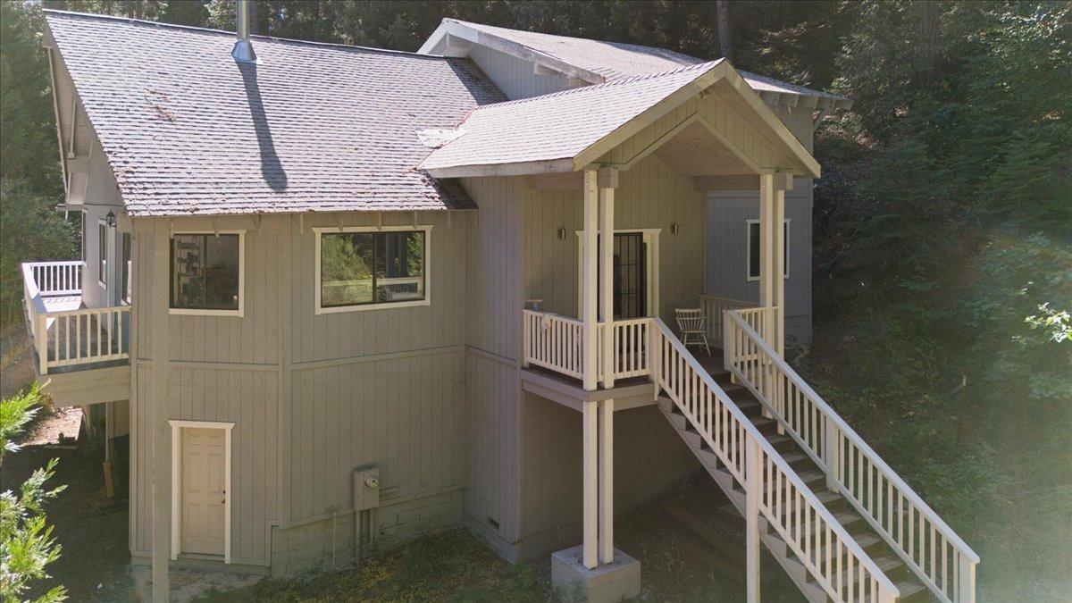 a view of a house with backyard and deck