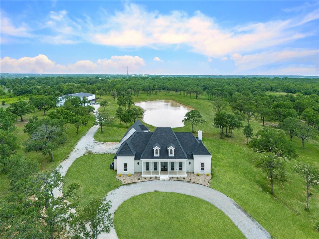 an aerial view of a house with a yard