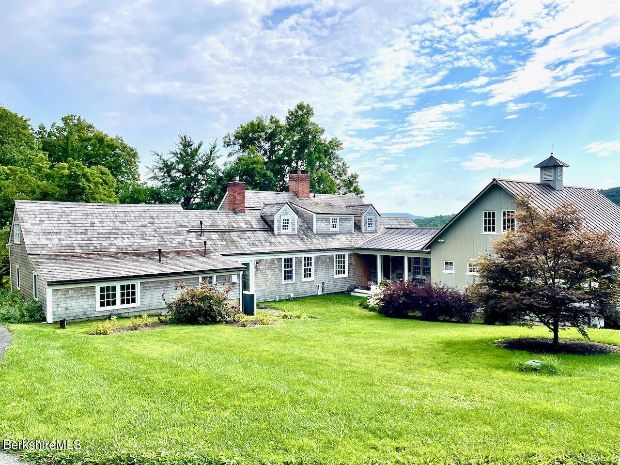 a aerial view of a house with a yard table and chairs