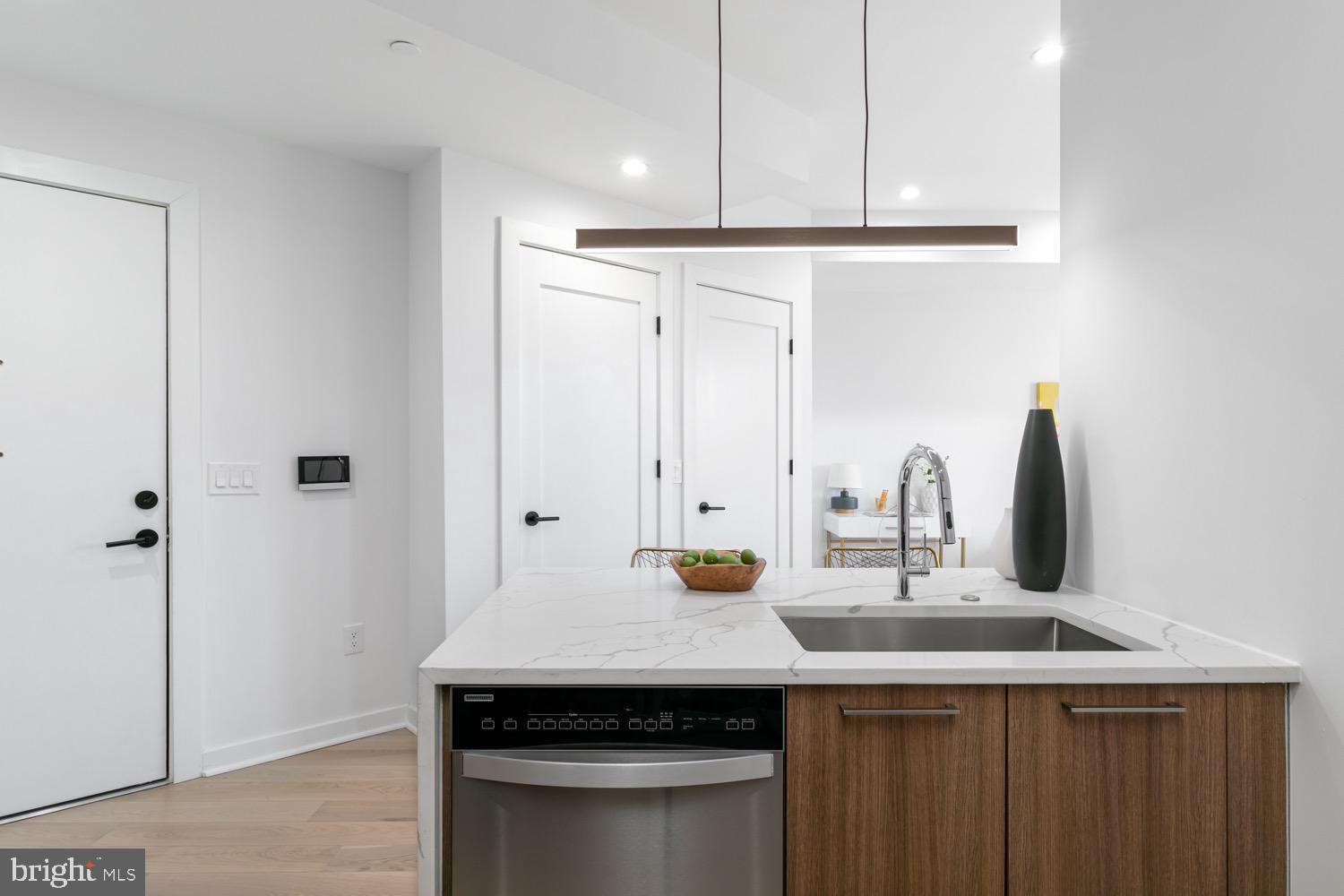 a kitchen with a sink and a refrigerator