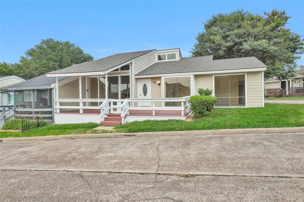 a front view of a house with a yard and potted plants