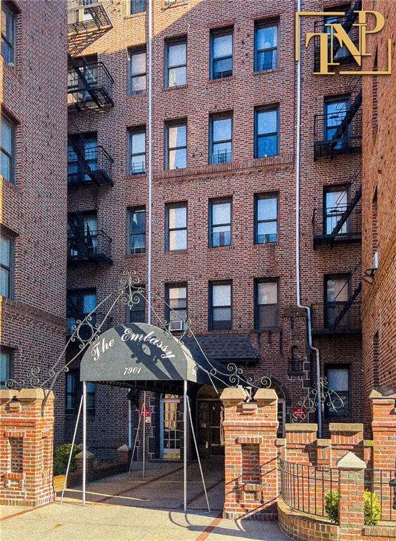 a view of a brick building with many windows