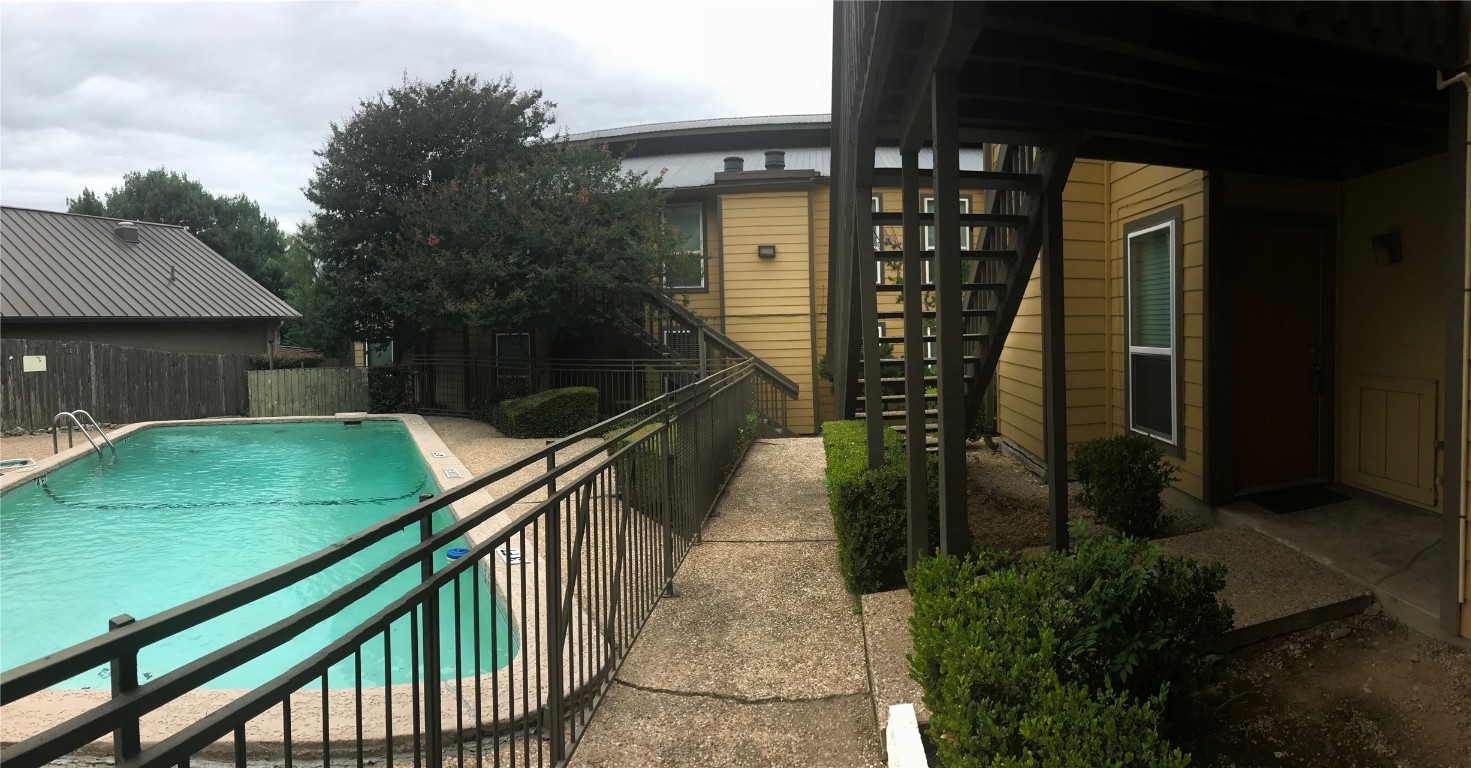 a balcony with lots of trees in the background