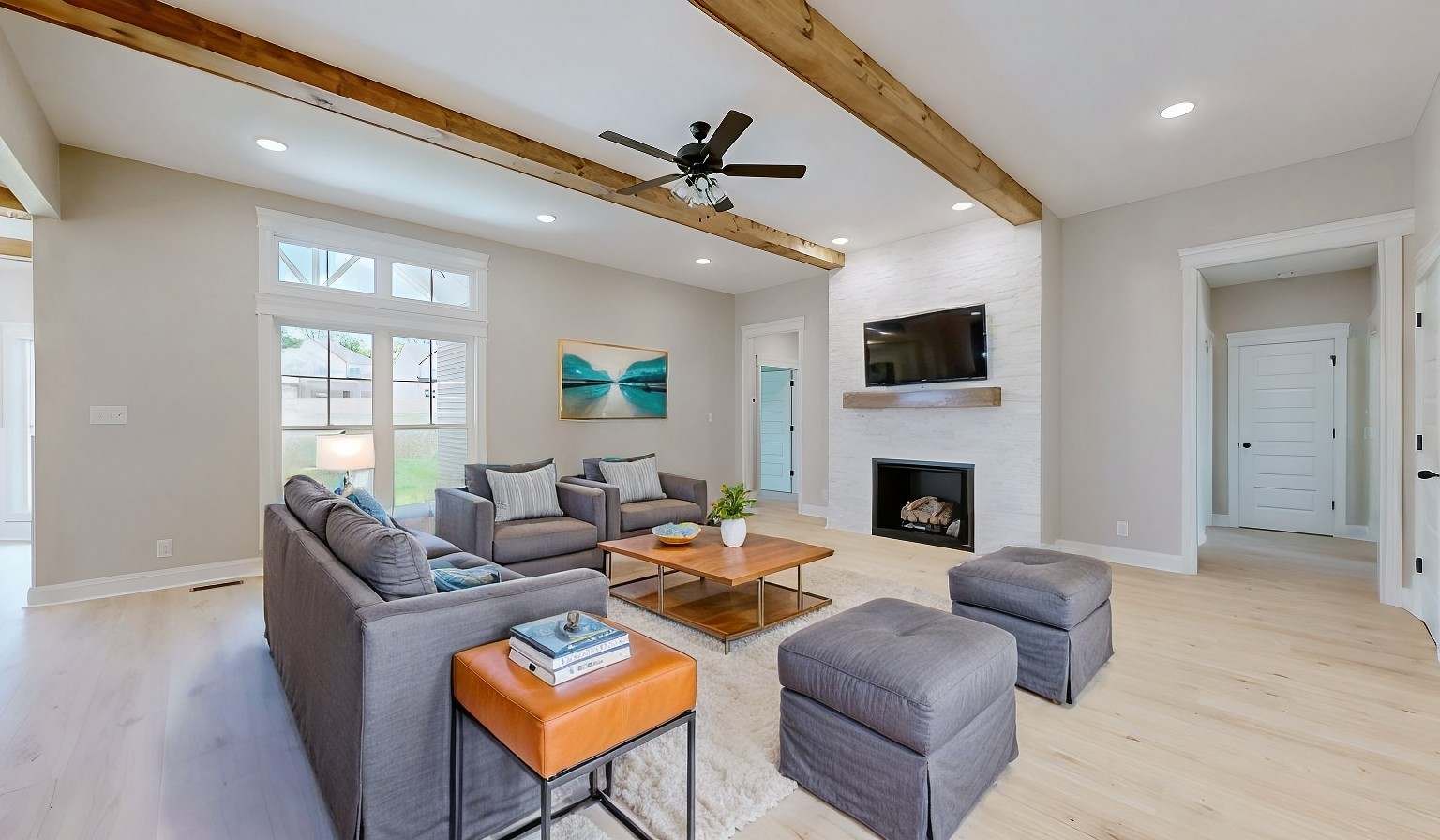 a living room with furniture a fireplace and a flat screen tv