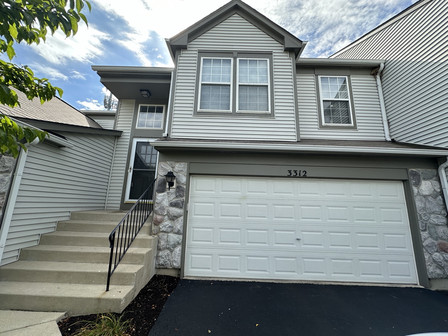 a front view of a house with a garage