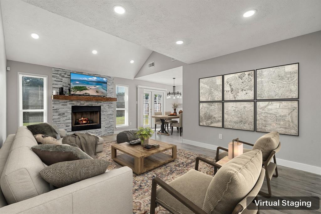 a living room with furniture fireplace and a large window