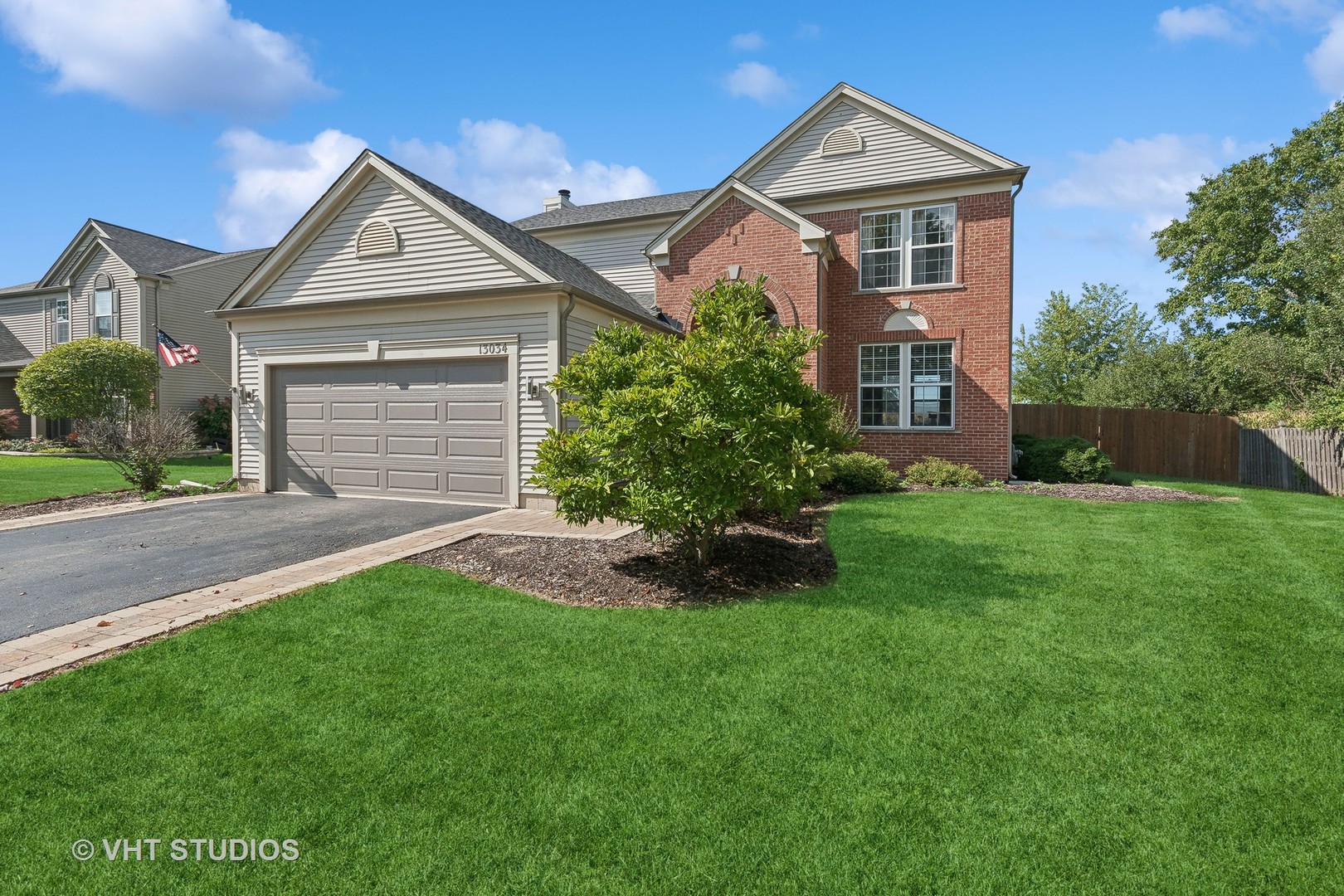 a front view of a house with a yard and trees