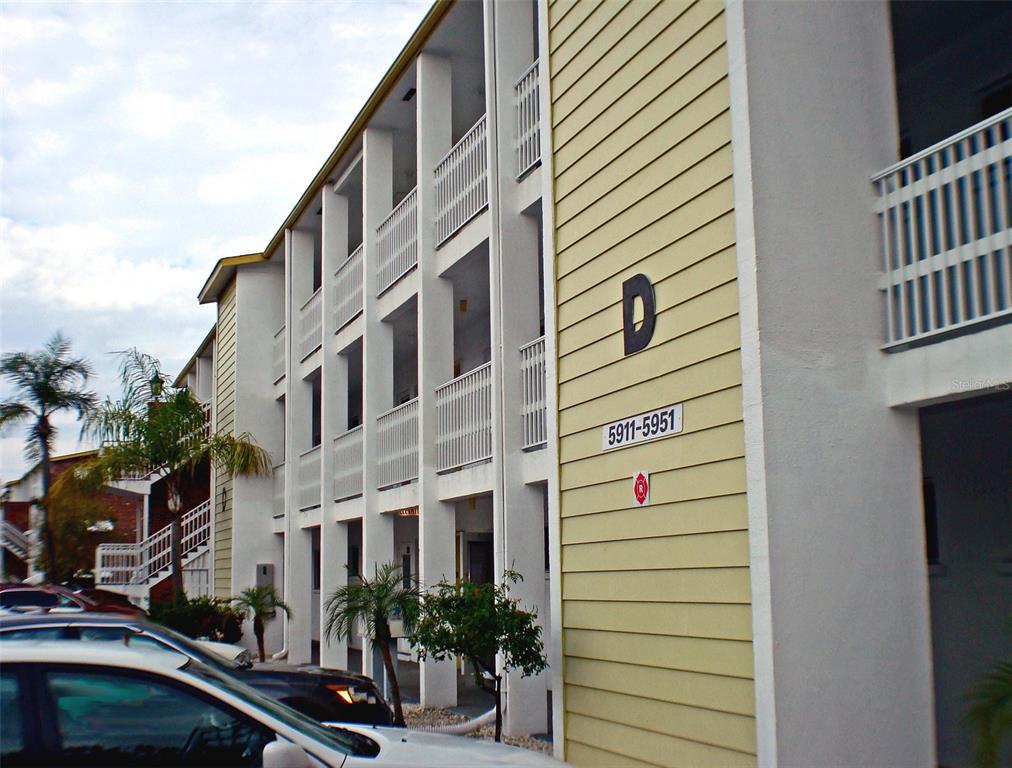 a front view of a building with plants