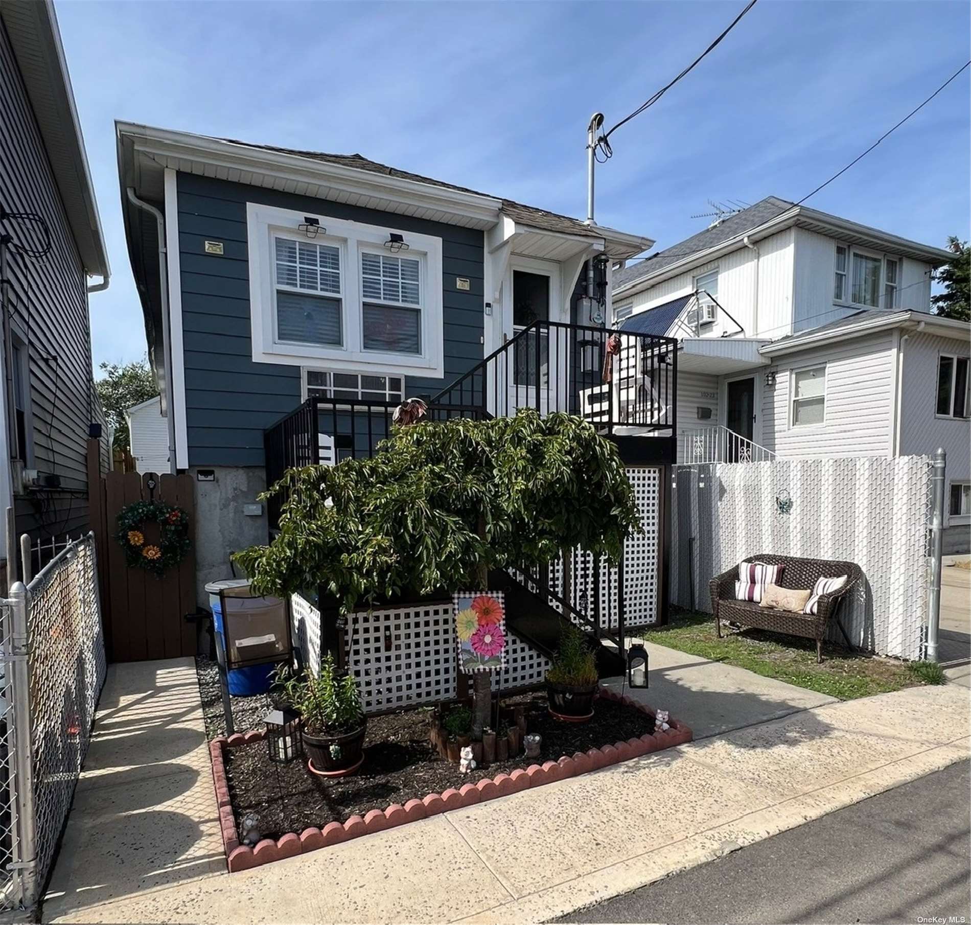 a front view of a house with a garden