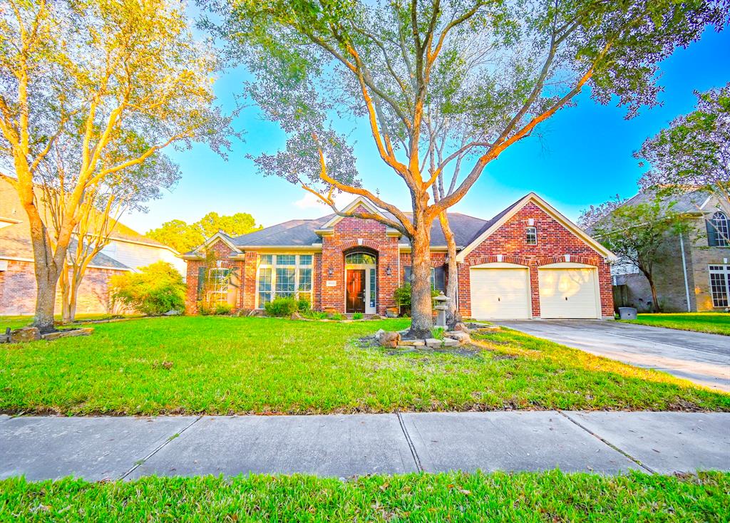 a front view of a house with a yard and garage