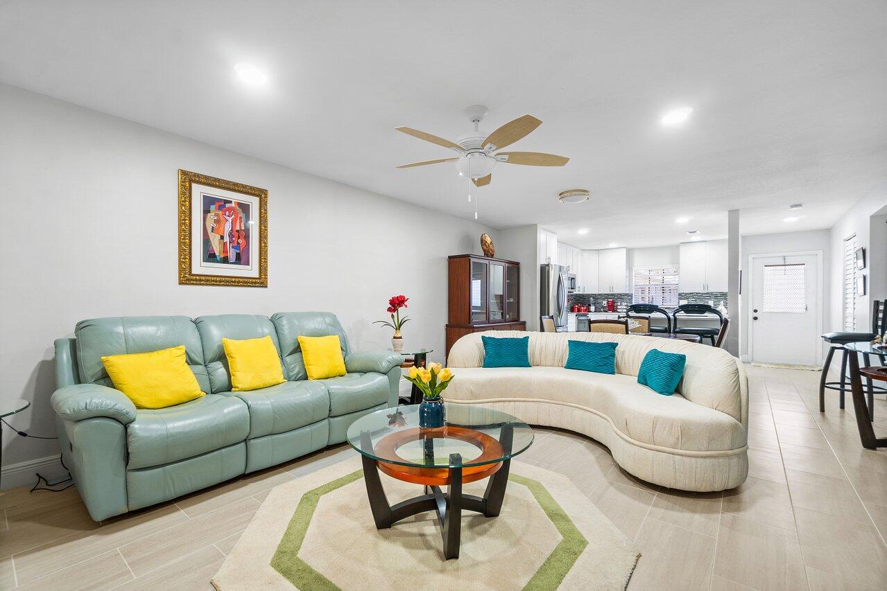 a living room with furniture and kitchen view