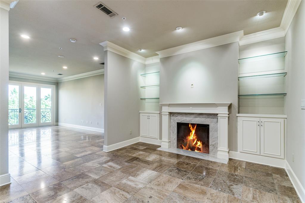 a view of an empty room with a fireplace and a window