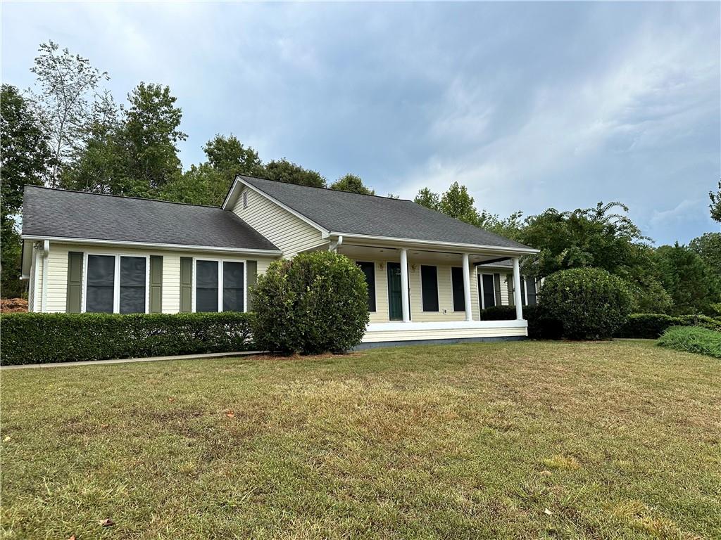 a front view of a house with a garden