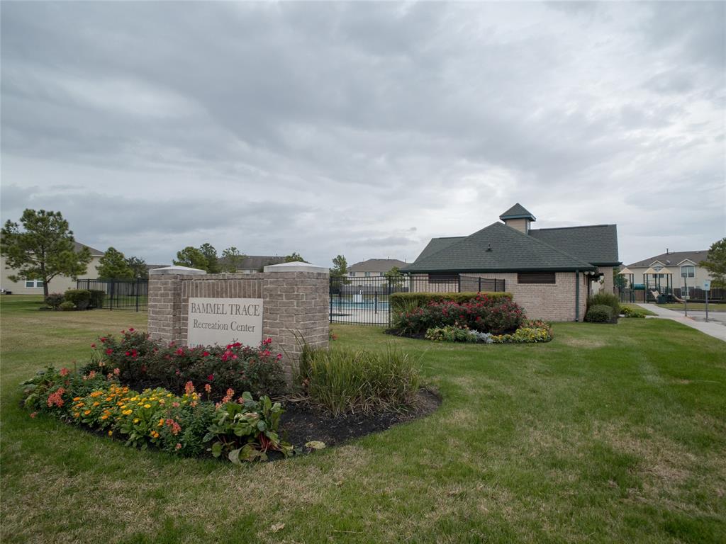 a front view of a house with a garden and yard