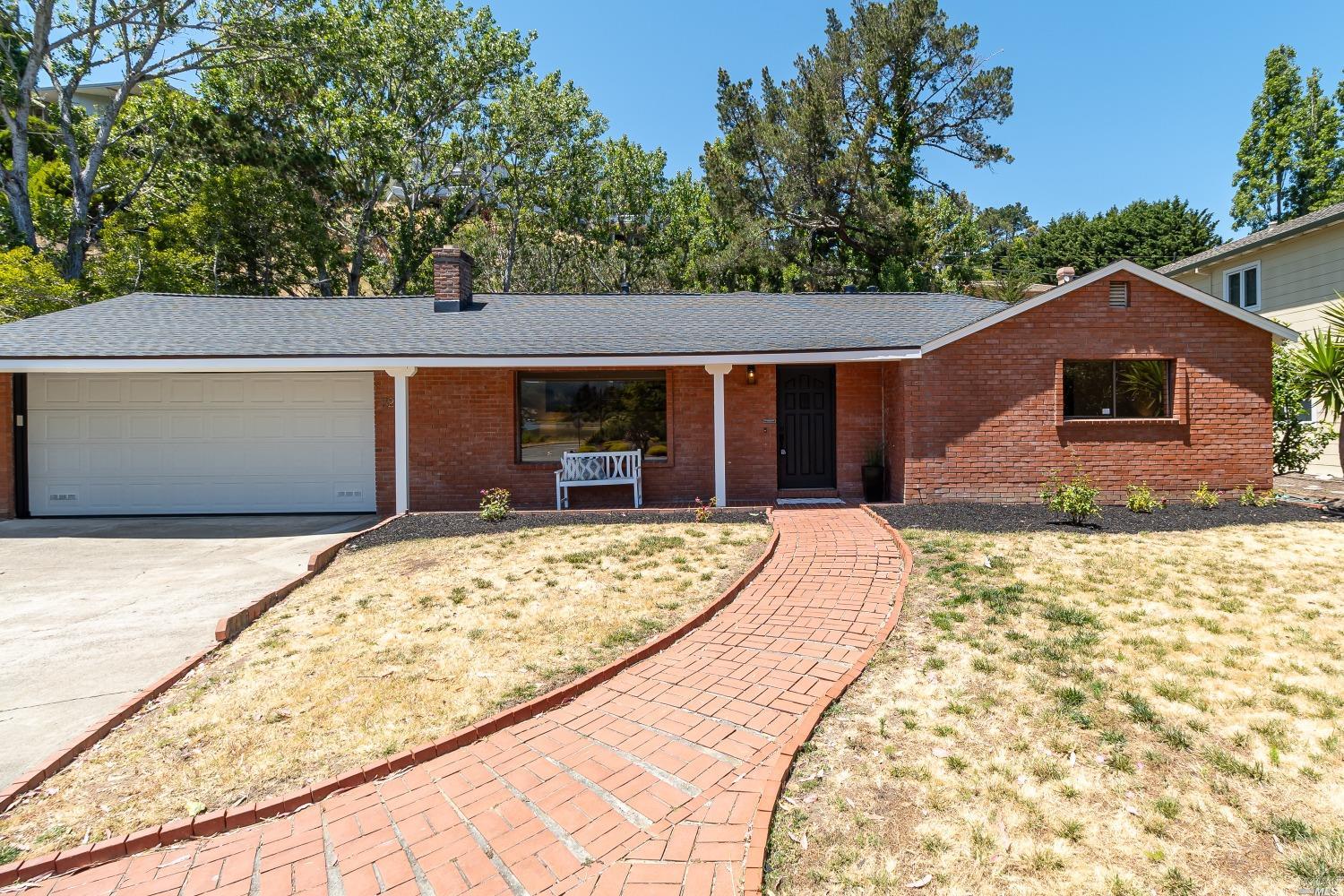 a front view of a house with a yard