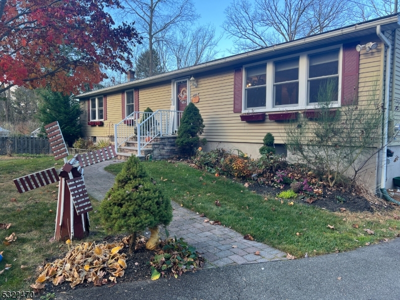 a front view of a house with a yard and garden