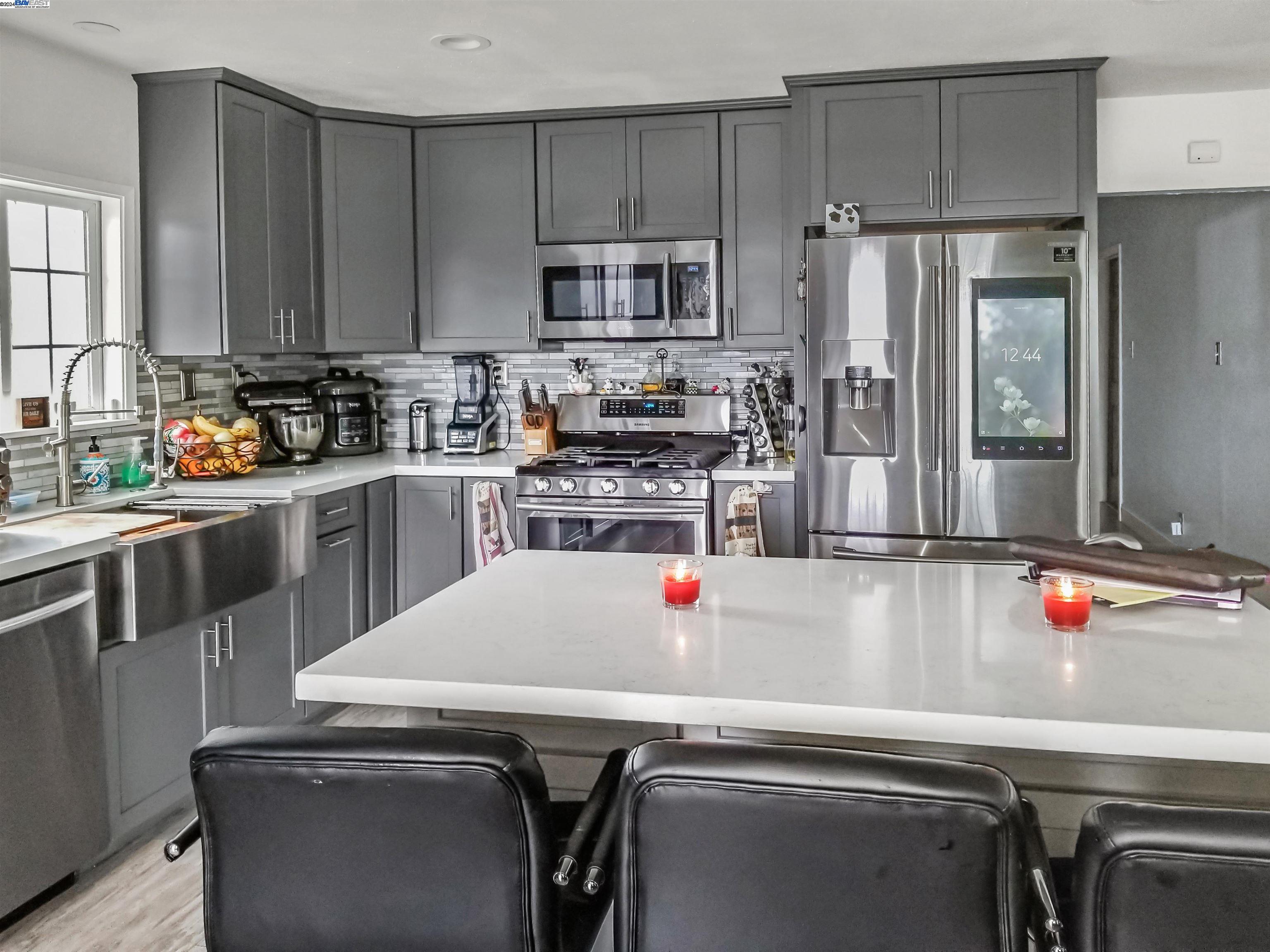 a kitchen with a sink and stainless steel appliances