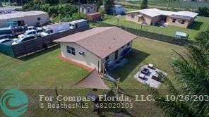 a aerial view of a house with garden space and street view